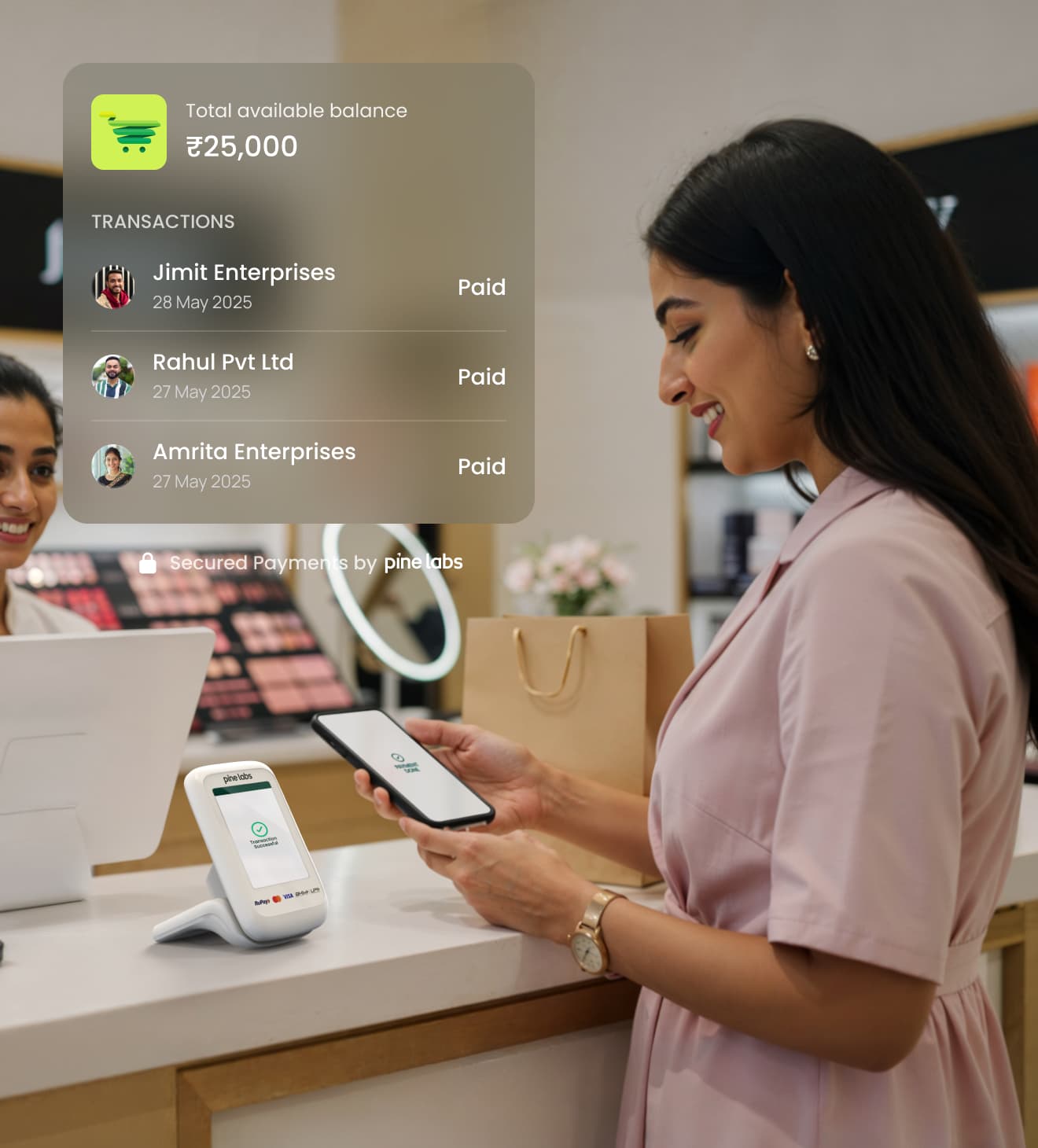 Customer making payment using a smartphone and Pine Labs VoicePod with transaction history display on screen