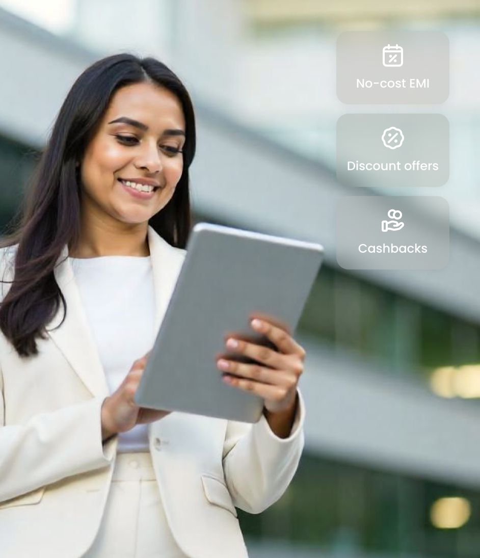 Woman using tablet with on-screen options for no-cost EMI, discounts, and cashback.