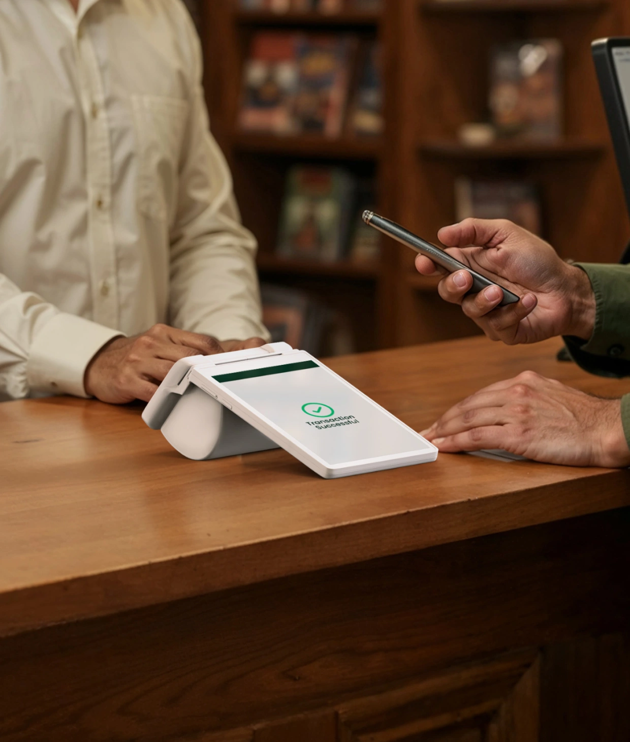 Customer making a payment using a smartphone on a Pine Labs PoS terminal at a retail counter Streamlined Checkout Experience with Pine Labs Terminal